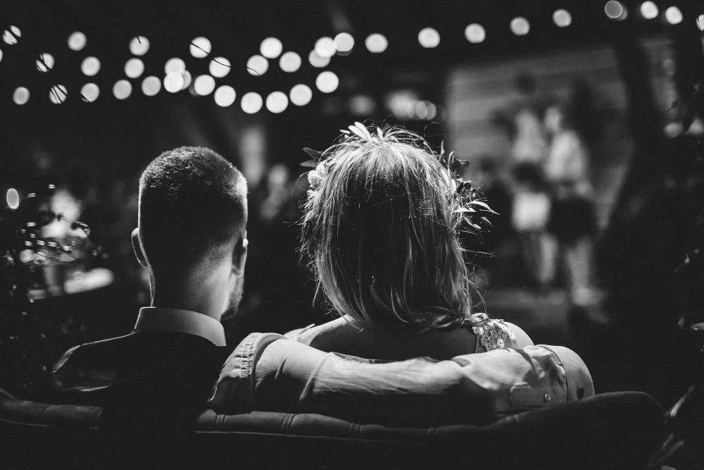 A couple sat together at a party
