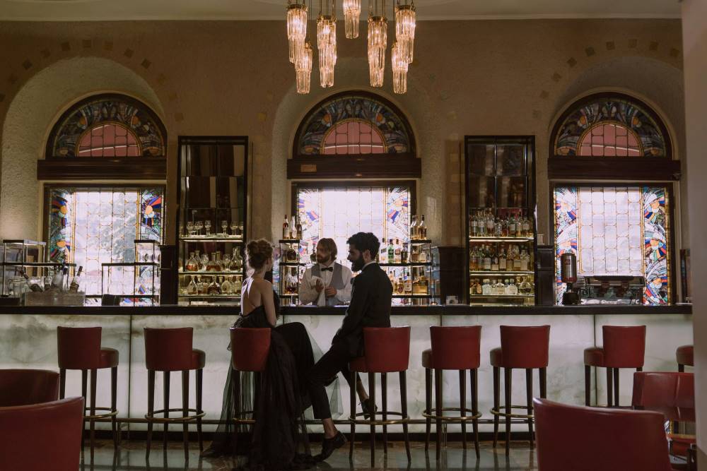 A couple sitting at a high-end bar 